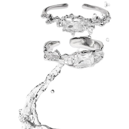 Two elegant silver crown couple rings featuring sparkling clear gemstones for a romantic touch