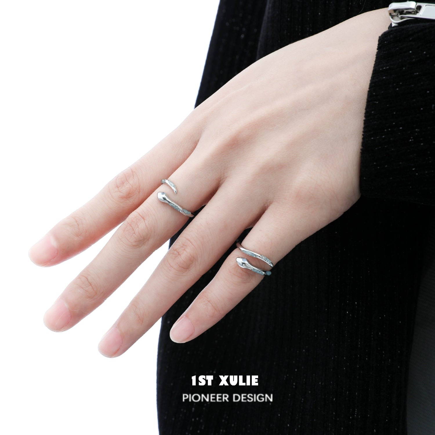 Elegant silver snake ring worn on a finger, showcasing a unique design by 1STXULIE