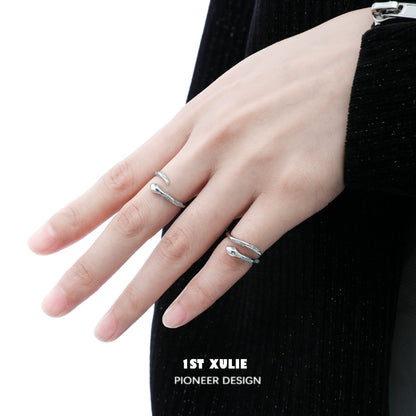 Elegant silver snake ring worn on a finger, showcasing a unique design by 1STXULIE