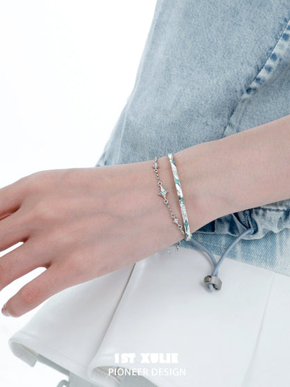 Elegant silver starlight bracelet on a hand, paired with a chic outfit for a stylish look