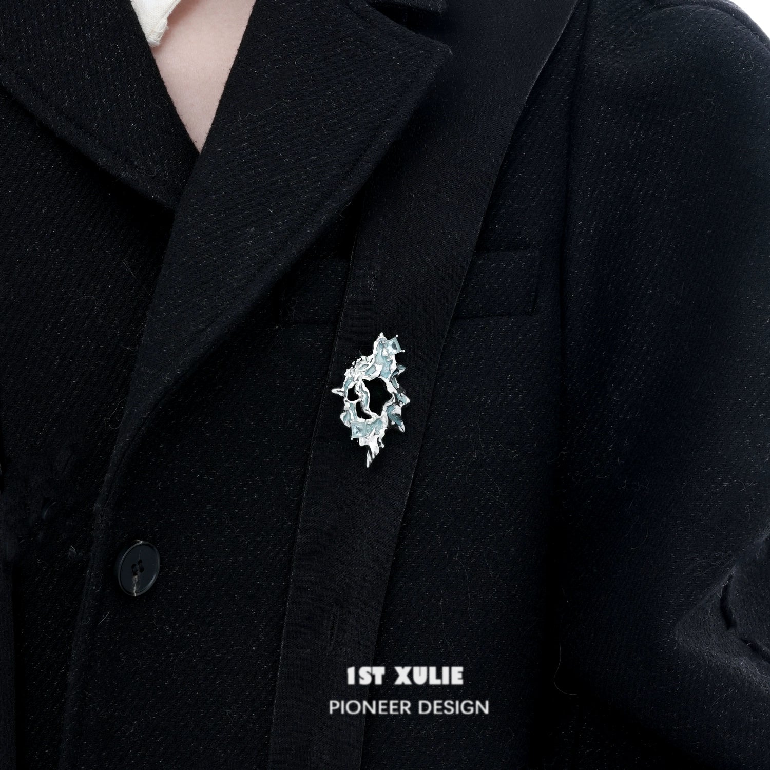 1STXULIE silver statement brooch with unique design worn on a black coat