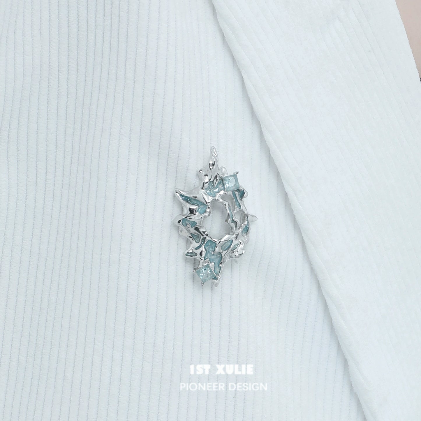 Elegant silver statement brooch featuring sparkling blue accents for stylish decor
