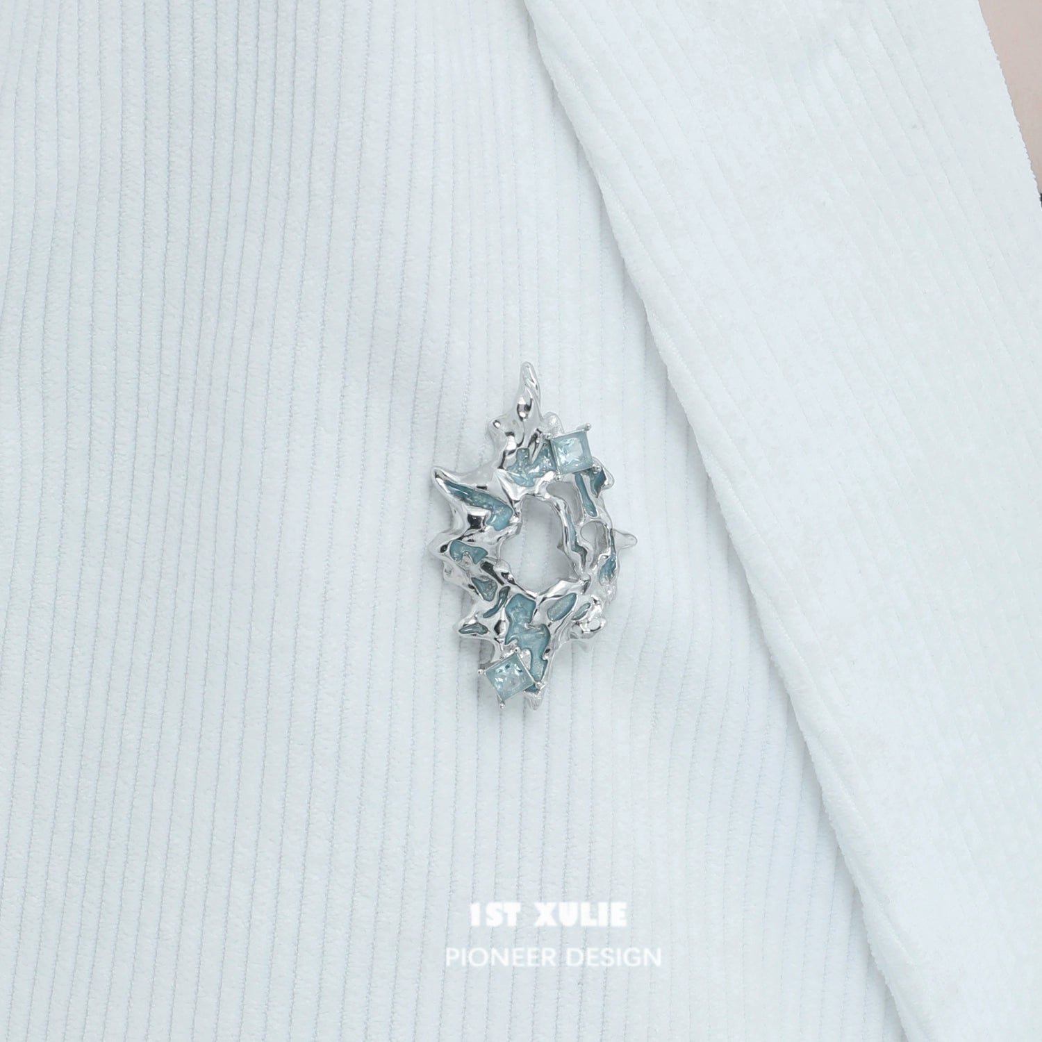 Elegant silver statement brooch featuring sparkling blue accents for stylish decor