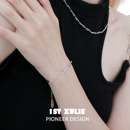 Stylish silver wave chain bracelet worn by a model, showcasing a modern and elegant design