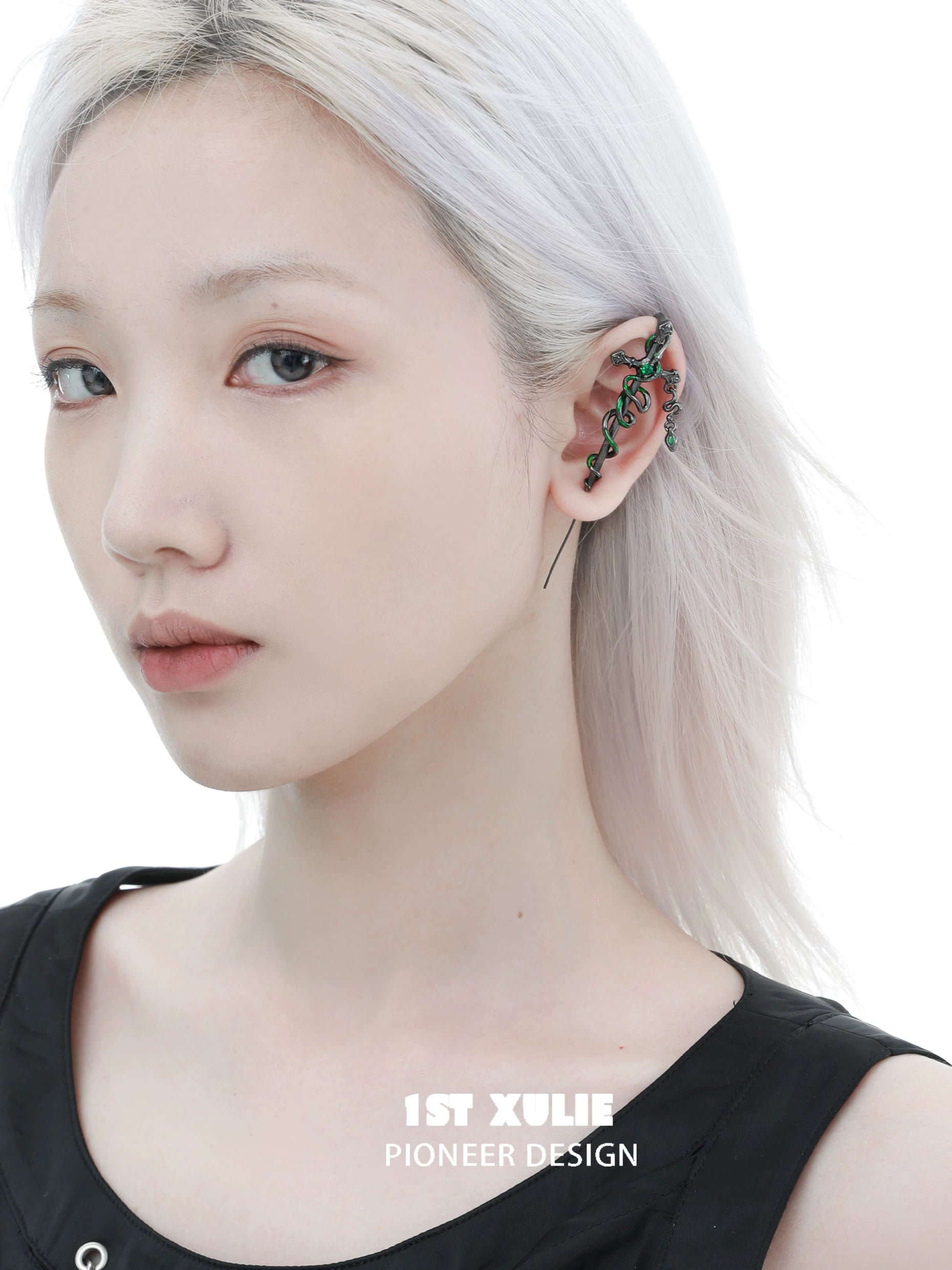 Slytherin cross piercing earring with a snake design on a model's ear for stylish accessories