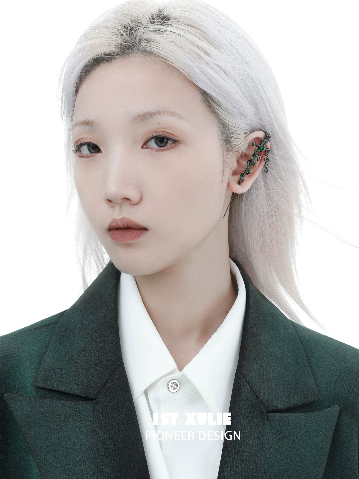 Slytherin cross piercing earring showcased on a model with sleek hair and a chic outfit