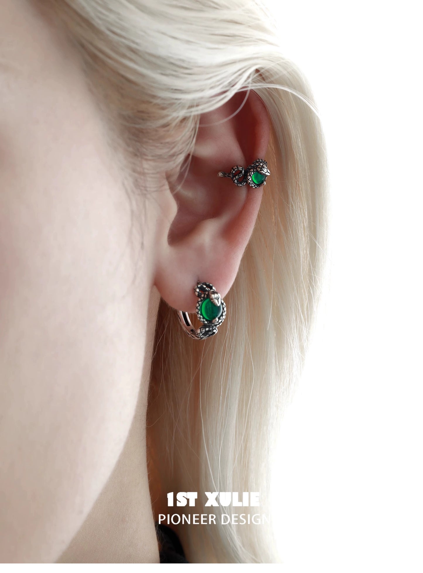 Slytherin snake ear cuff in silver with green accents worn on a model's ear