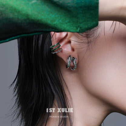 Slytherin snake ear cuff designed by 1STXULIE featuring a detailed serpent design in silver and green
