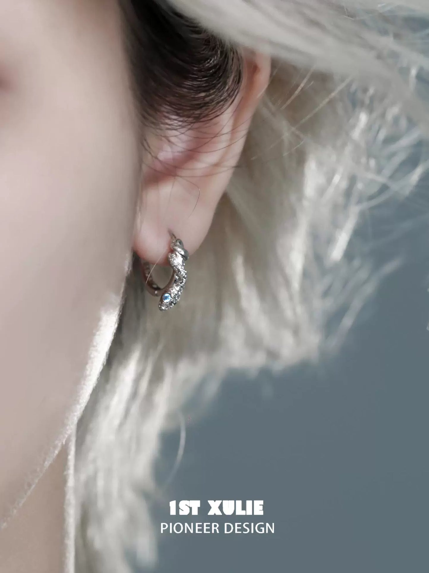 Silver snake hoop earrings featuring an intricate design for stylish jewelry lovers