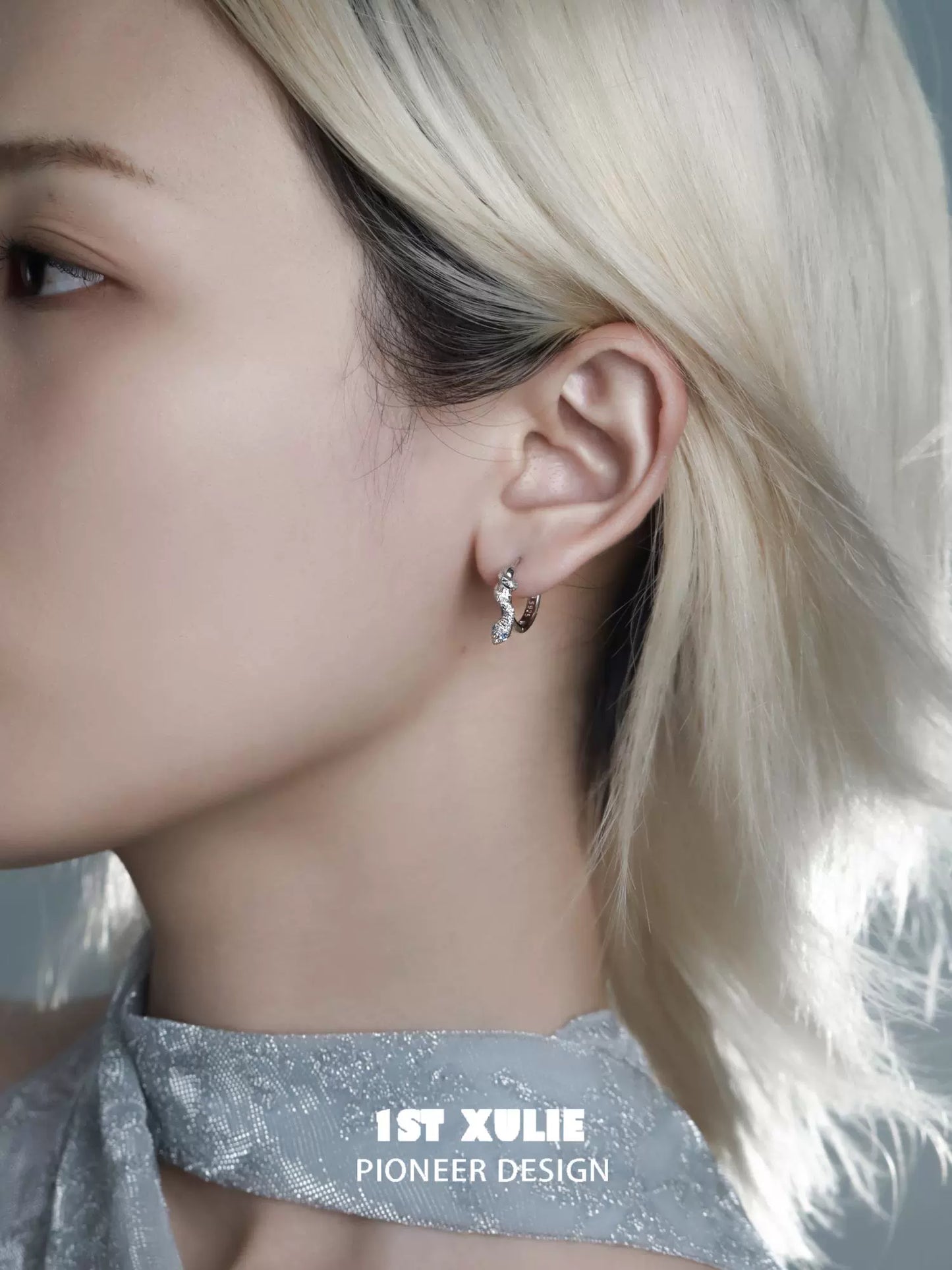 Stylish snake hoop earrings silver showcased on a model with short light hair