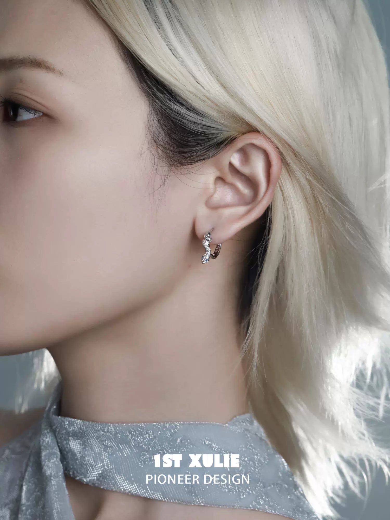 Stylish snake hoop earrings silver showcased on a model with short light hair