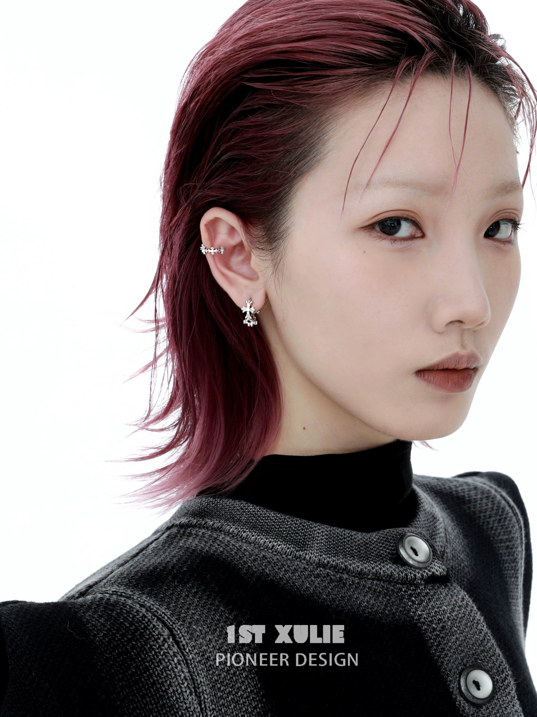 Model wearing 1STXULIE spiked cross earrings showcasing a modern and edgy design.