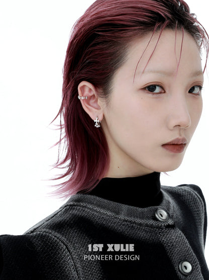 Model wearing 1STXULIE spiked cross earrings showcasing a modern and edgy design.