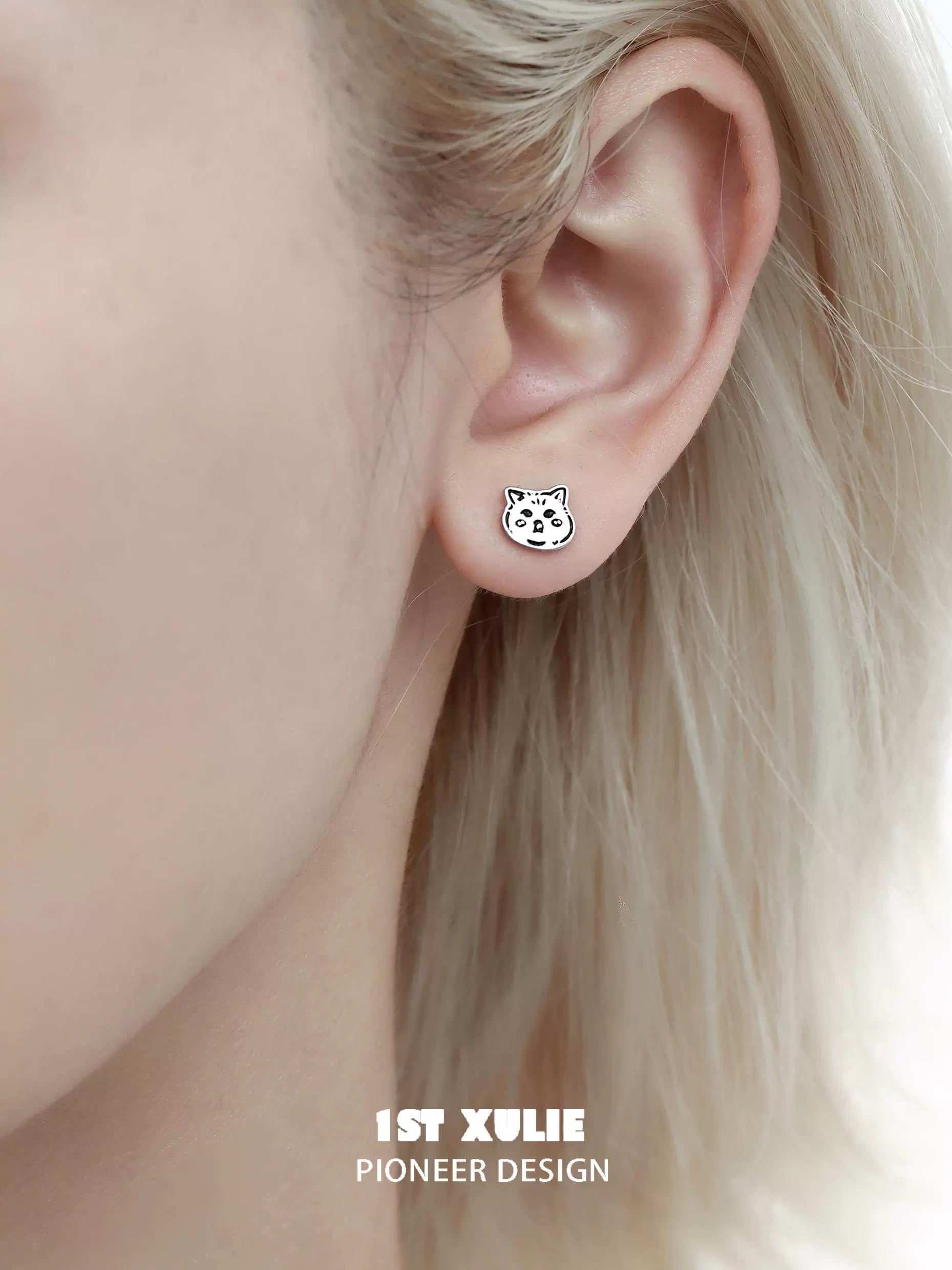 Cute street art cat earrings displayed on an ear, perfect for art lovers and unique jewelry enthusiasts