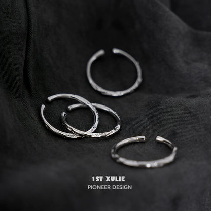 Set of four elegant textured silver rings with unique designs, perfect for stacking or solo wear