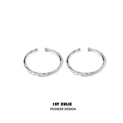 Textured silver ring from 1STXULIE showcases a unique design with intricate detailing