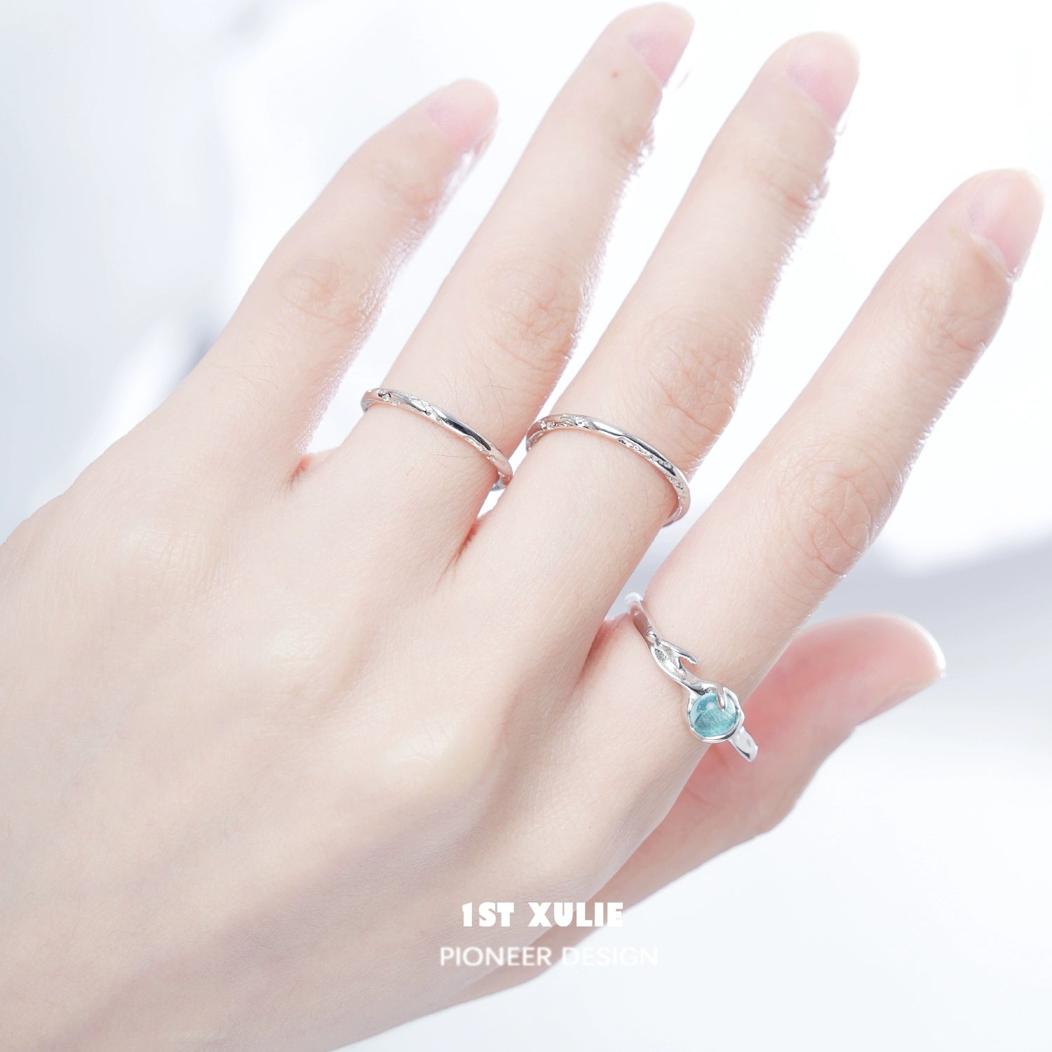 Minimalistic textured silver ring worn alongside a delicate gemstone ring for an elegant look