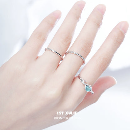 Minimalistic textured silver ring worn alongside a delicate gemstone ring for an elegant look