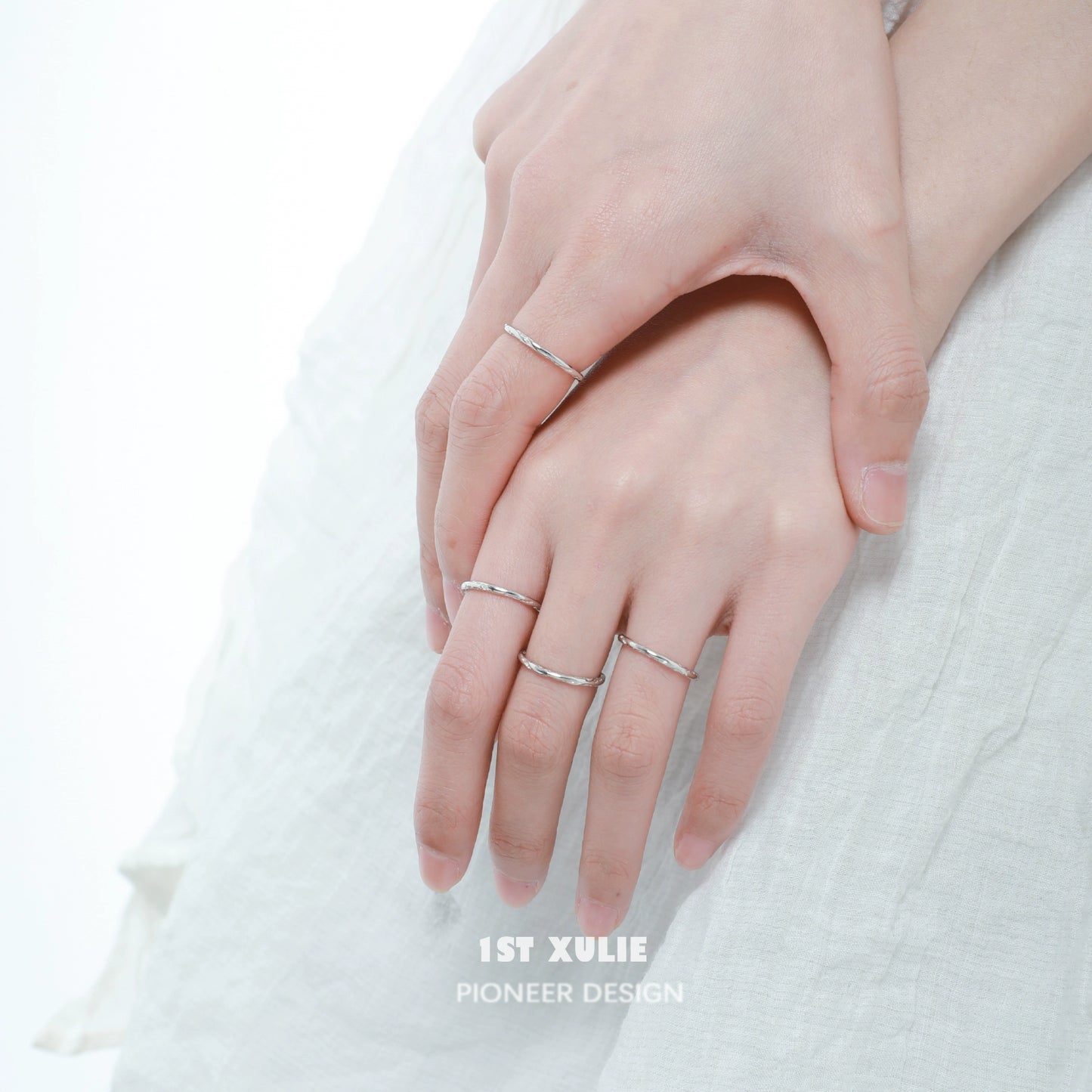 Set of textured silver rings worn on fingers for a stylish and elegant look