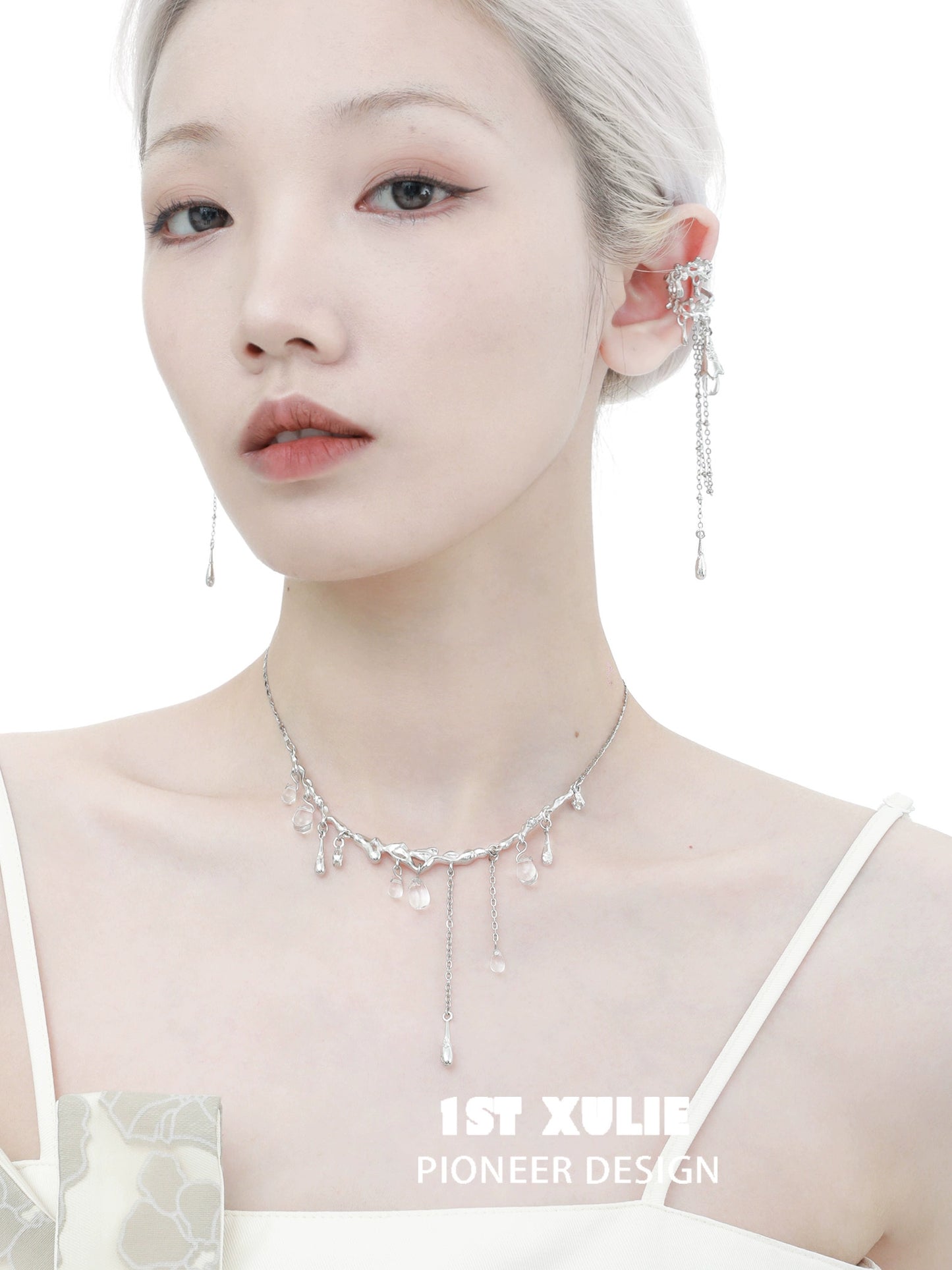 Model wearing 1STXULIE tidal wave ear cuffs with a sleek silver design that complements her elegant look