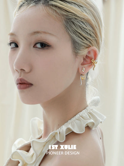 Elegant model showcasing twisted bow earrings in gold with unique design elements