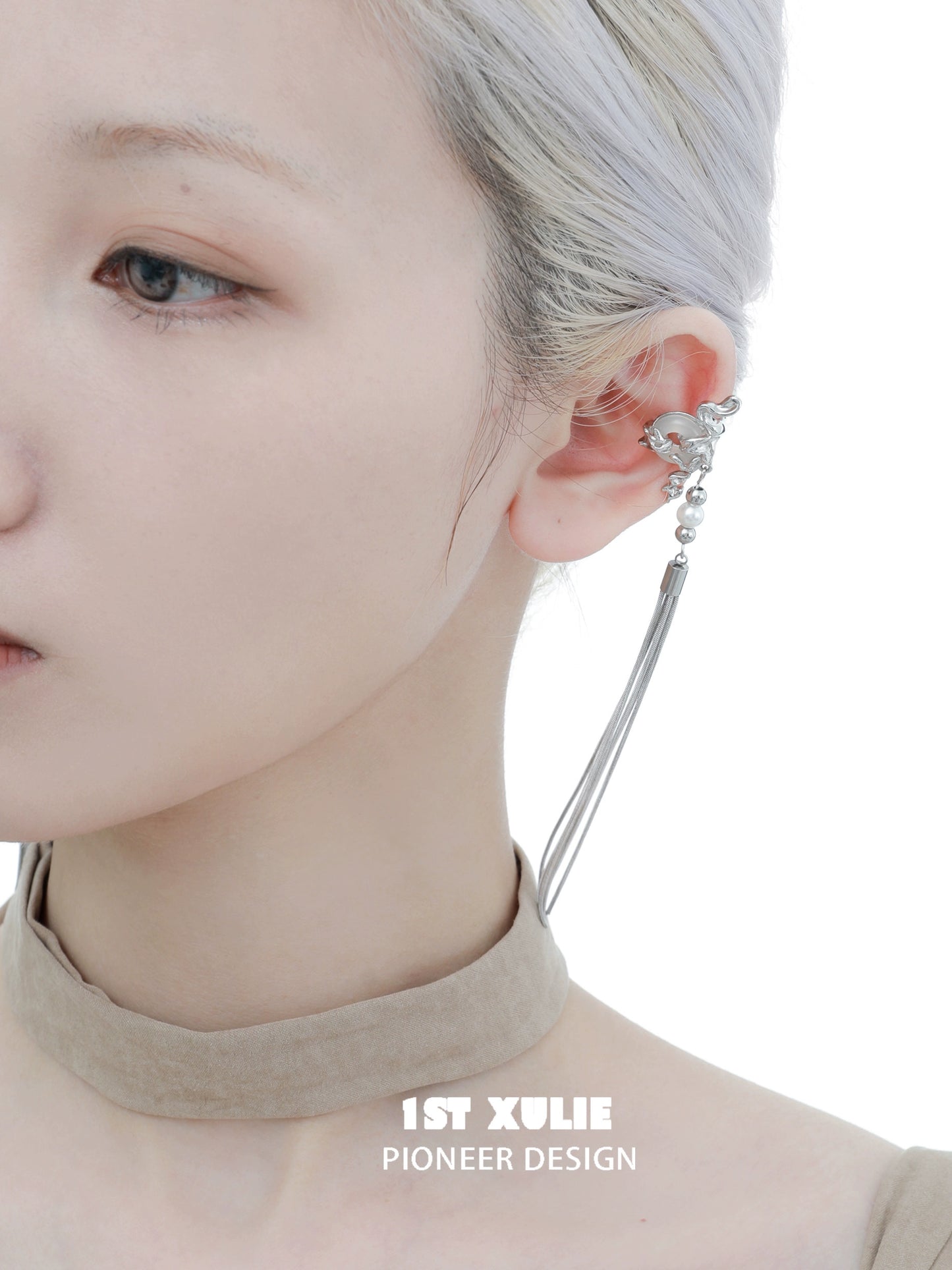 Unique tassel earrings in silver design worn on a model with a sleek hairstyle