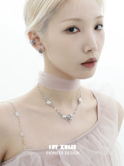 Elegant model wearing velvet rose stud earrings paired with a stylish choker and silver necklace
