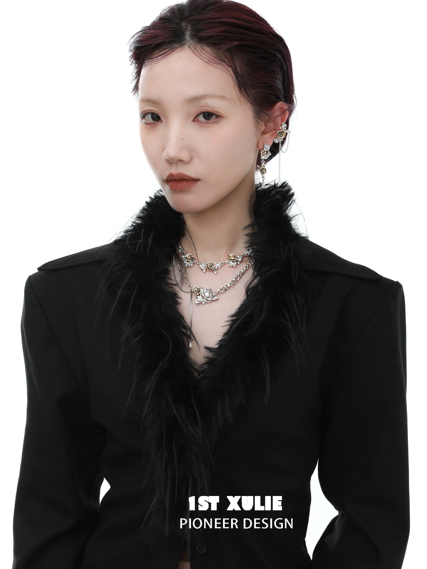 Model wearing a vintage rose necklace layered with silver chains for a chic look