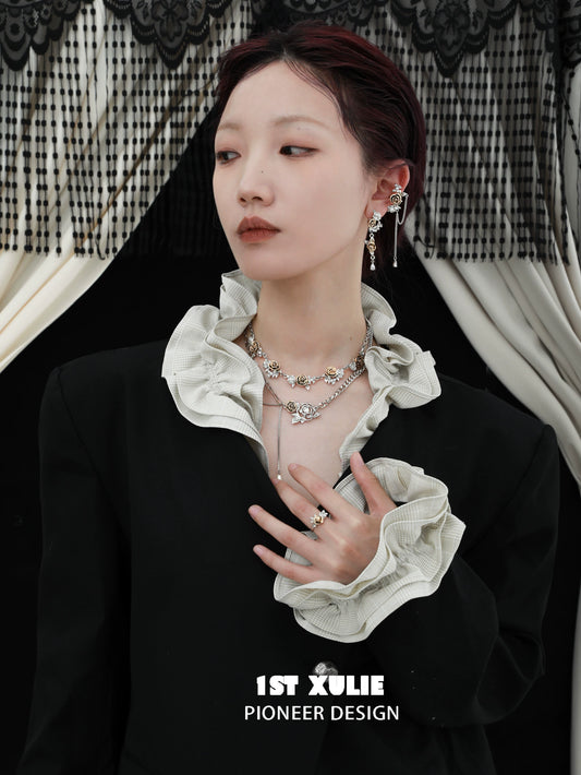 Elegant model wearing a vintage rose necklace with a stylish black outfit and refined accessories