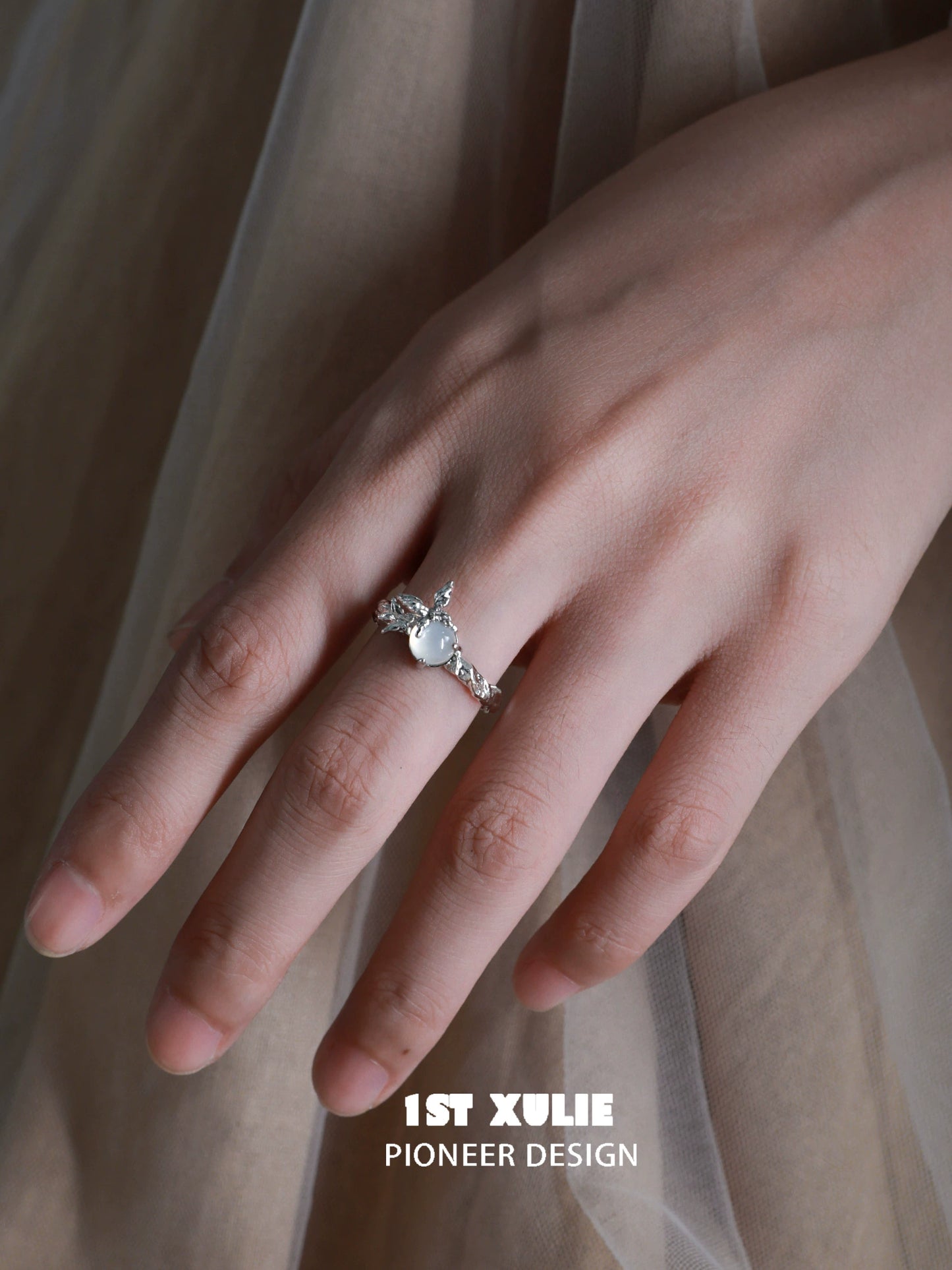 Elegant white agate butterfly silver ring displayed on a model's hand showcasing intricate design