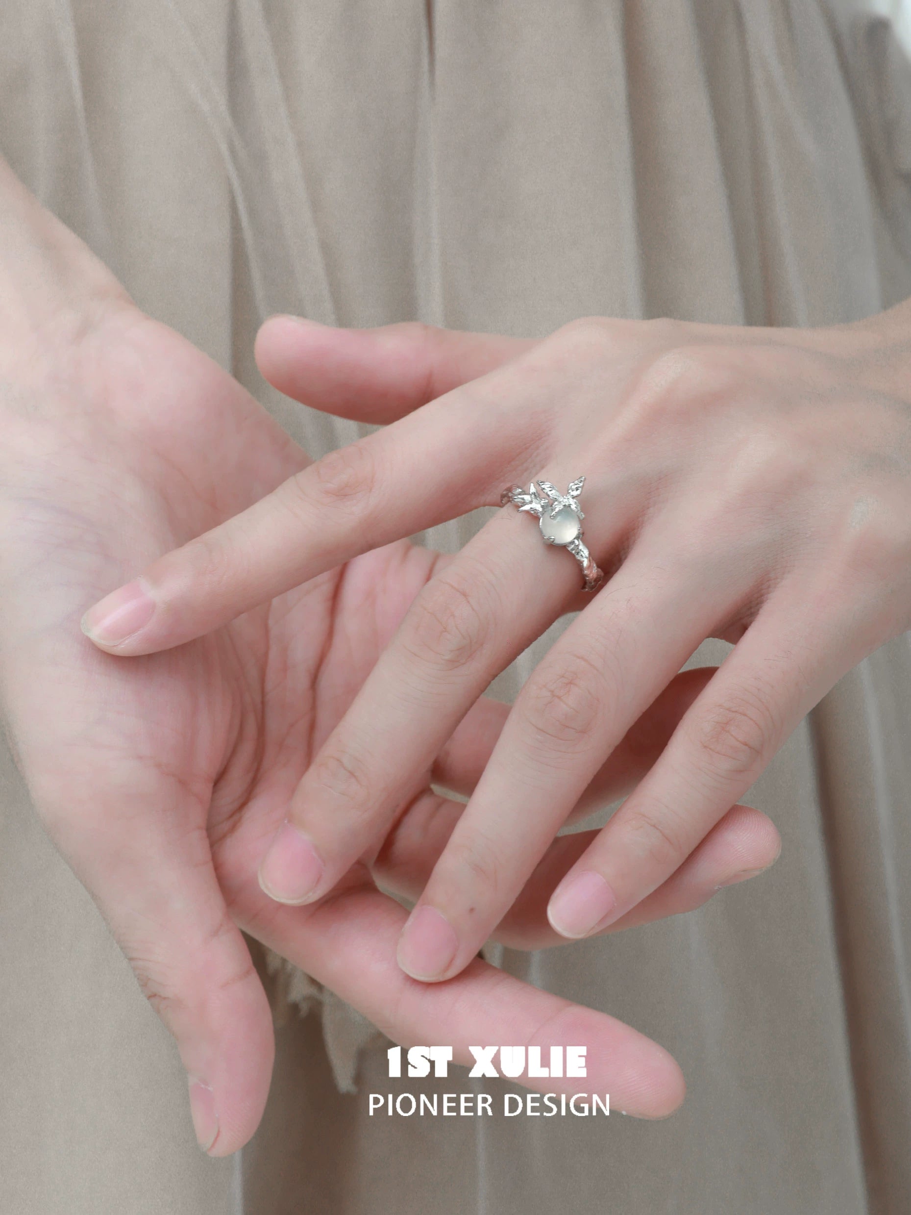 Elegant white agate butterfly silver ring featured on a model's hand with delicate design
