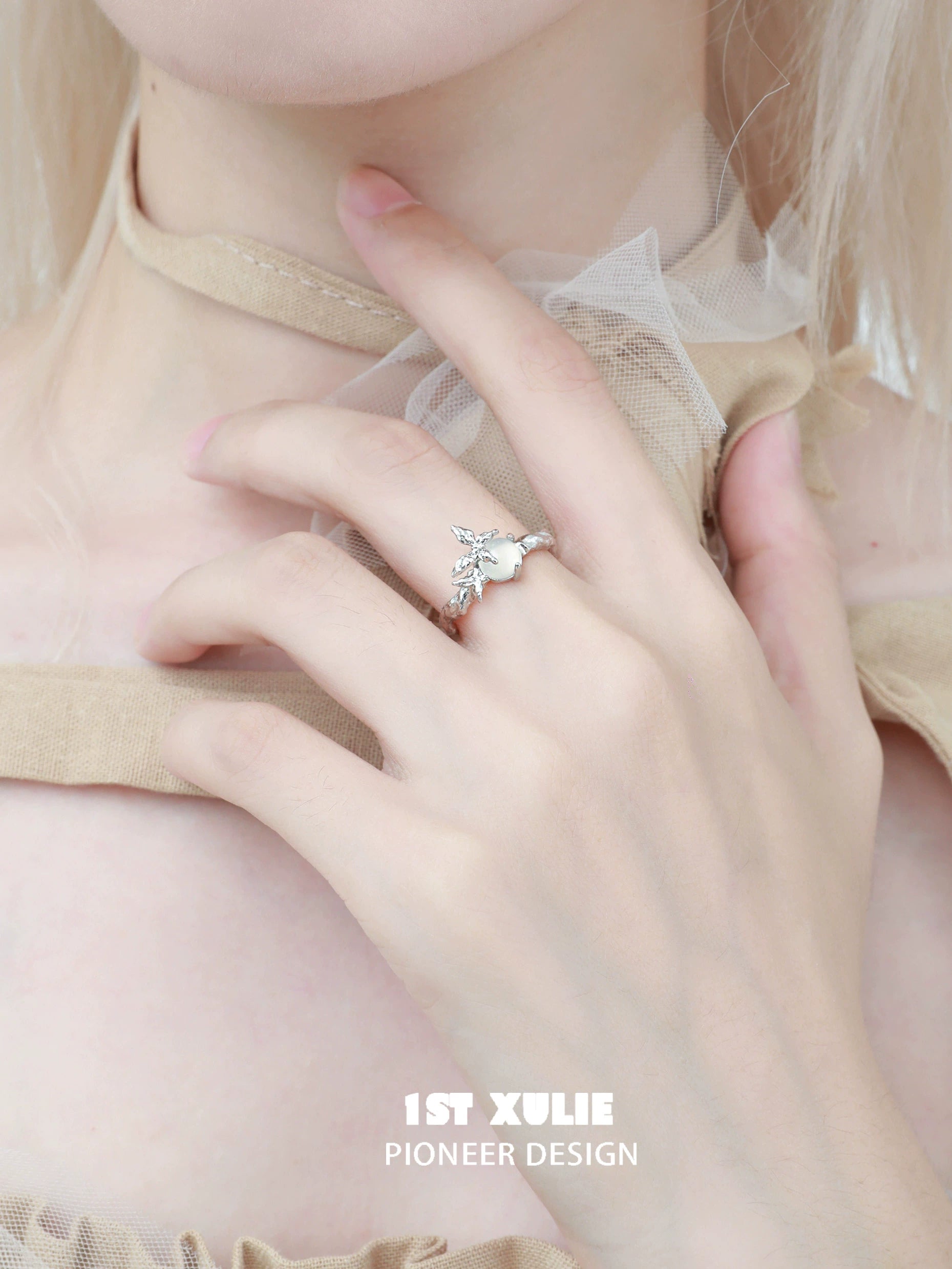 Beautiful white agate butterfly silver ring worn elegantly on a hand with a delicate outfit