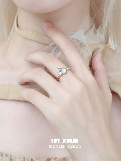 Beautiful white agate butterfly silver ring worn elegantly on a hand with a delicate outfit