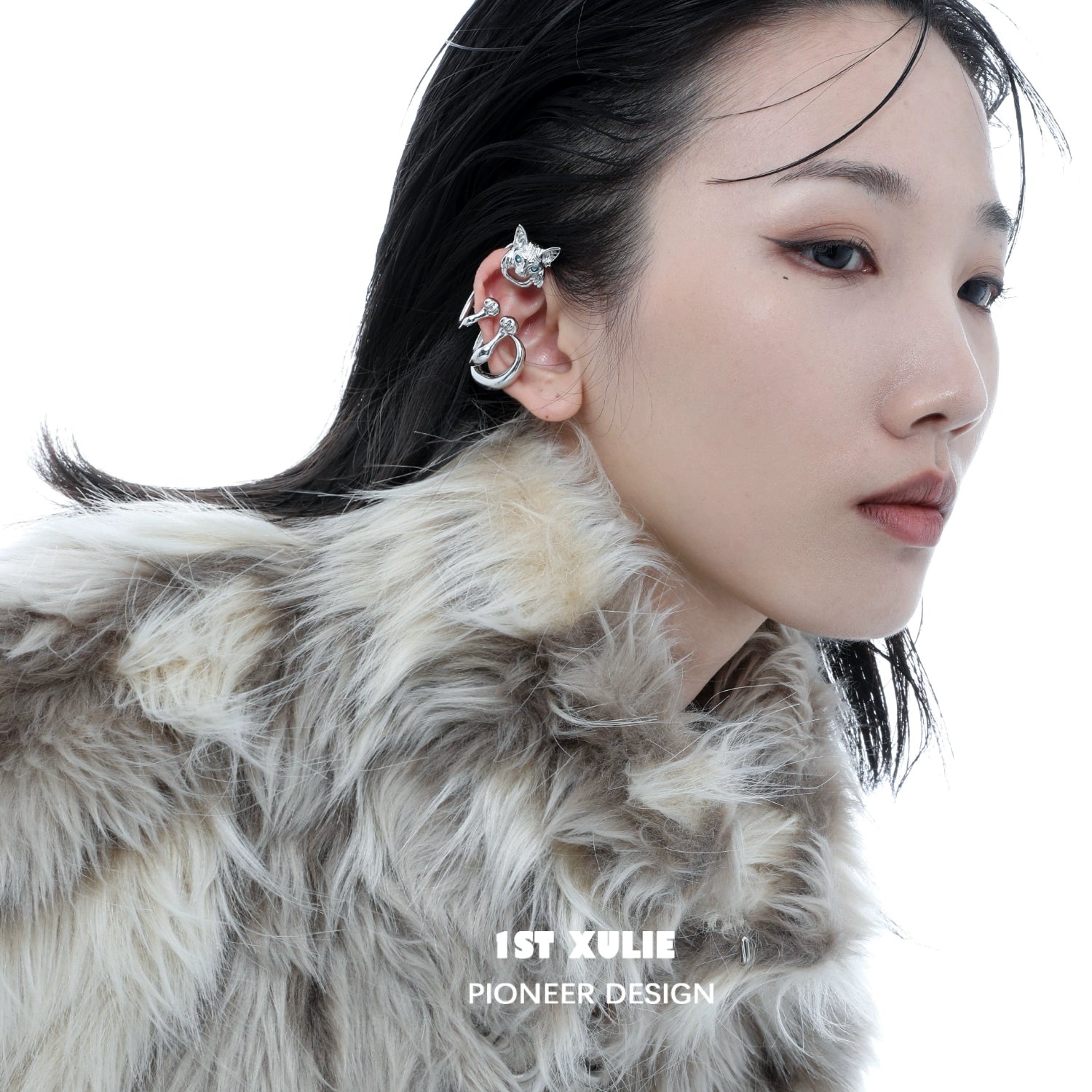 Y2K cat ear cuff in silver worn on a model's ear with stylish makeup and fur coat