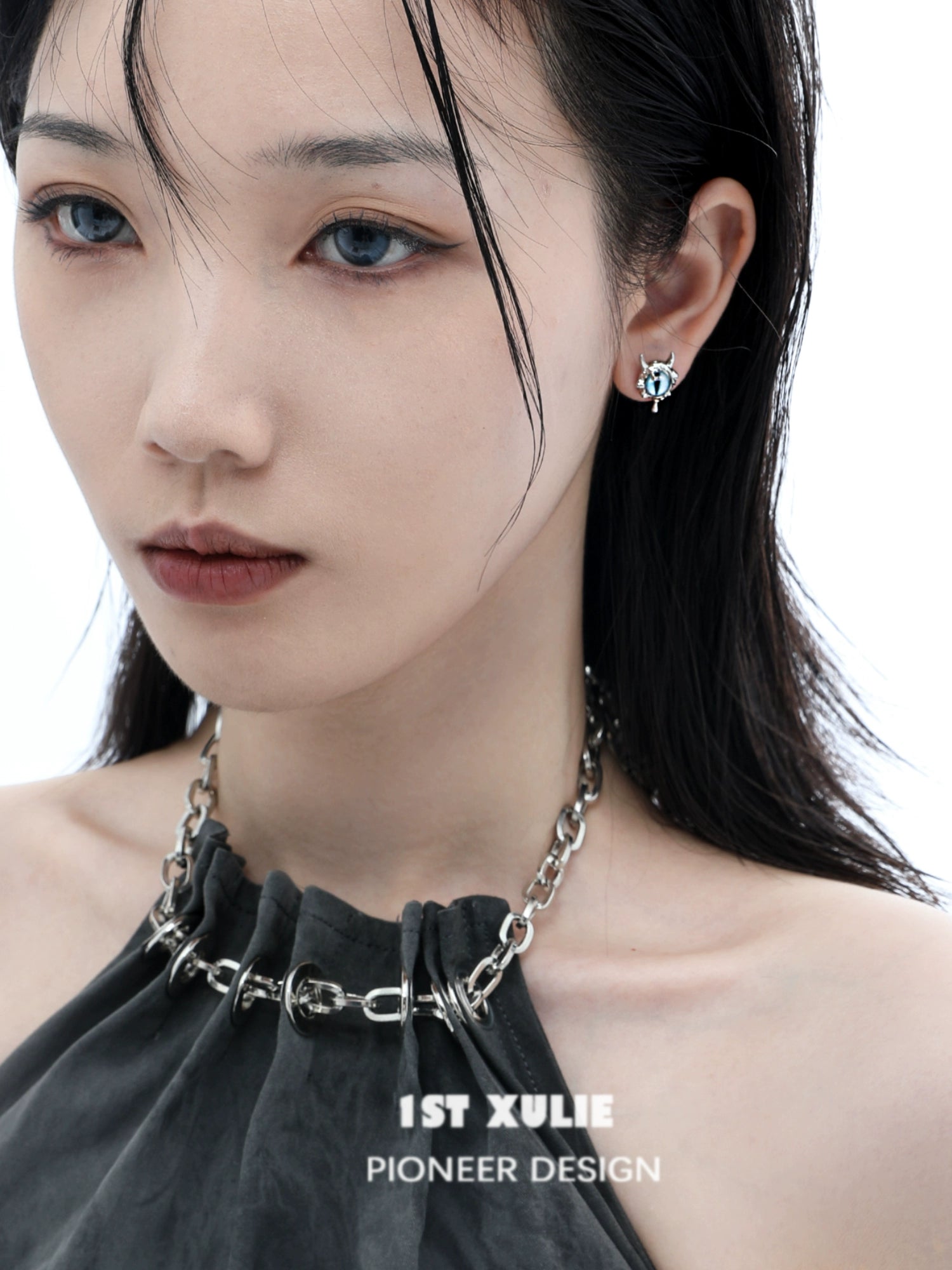 Stylish Y2K demon eye earrings worn by a model with a smoky look and sleek hairstyle