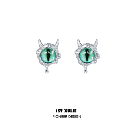 Y2K demon eye earrings in silver with green eye detail and intricate design