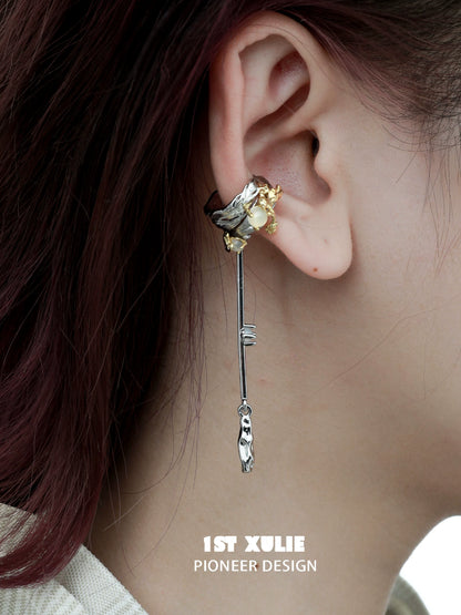 Y2K feather tassel ear clip featuring a unique design with silver and gold embellishments