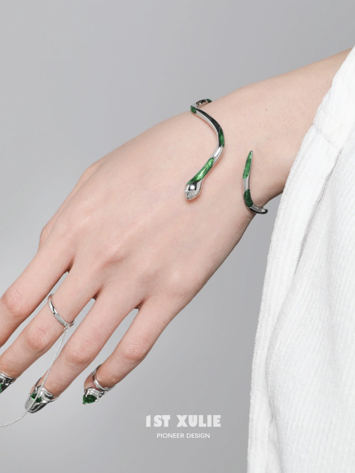 Y2K Slytherin snake bracelet in silver and green design worn on a hand with stylish nails