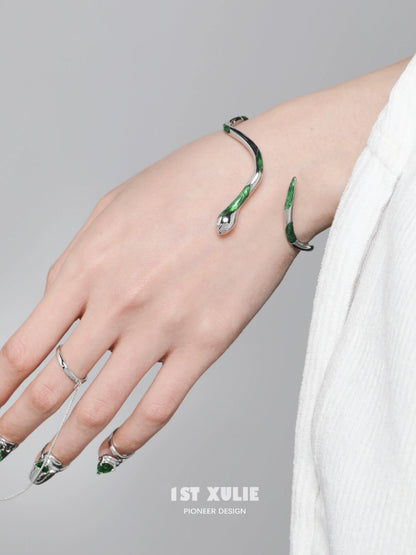 Y2K Slytherin snake bracelet in silver and green design worn on a hand with stylish nails