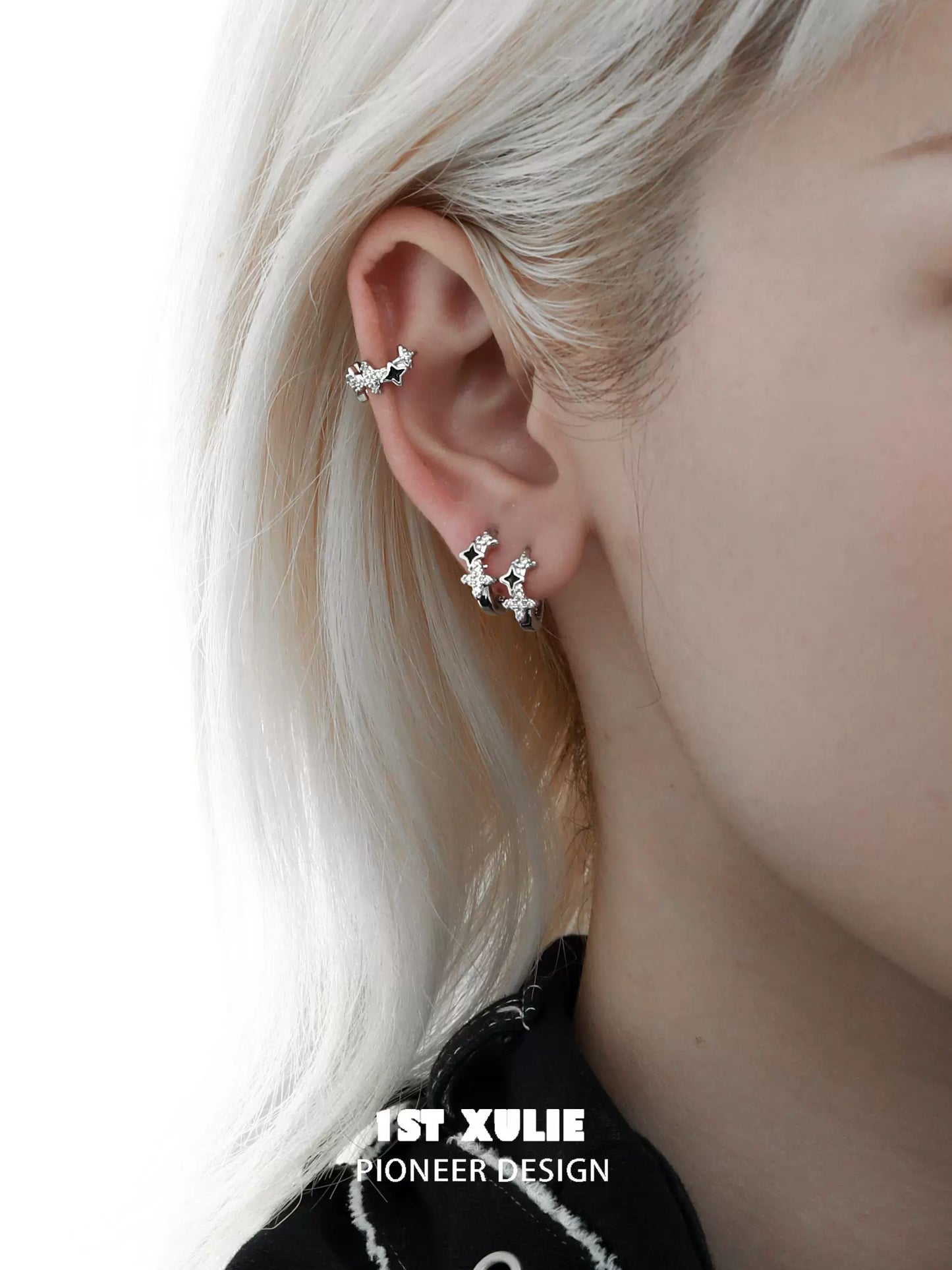 Y2K starpunk thorn earrings worn by a model with silver hair on a minimalist background