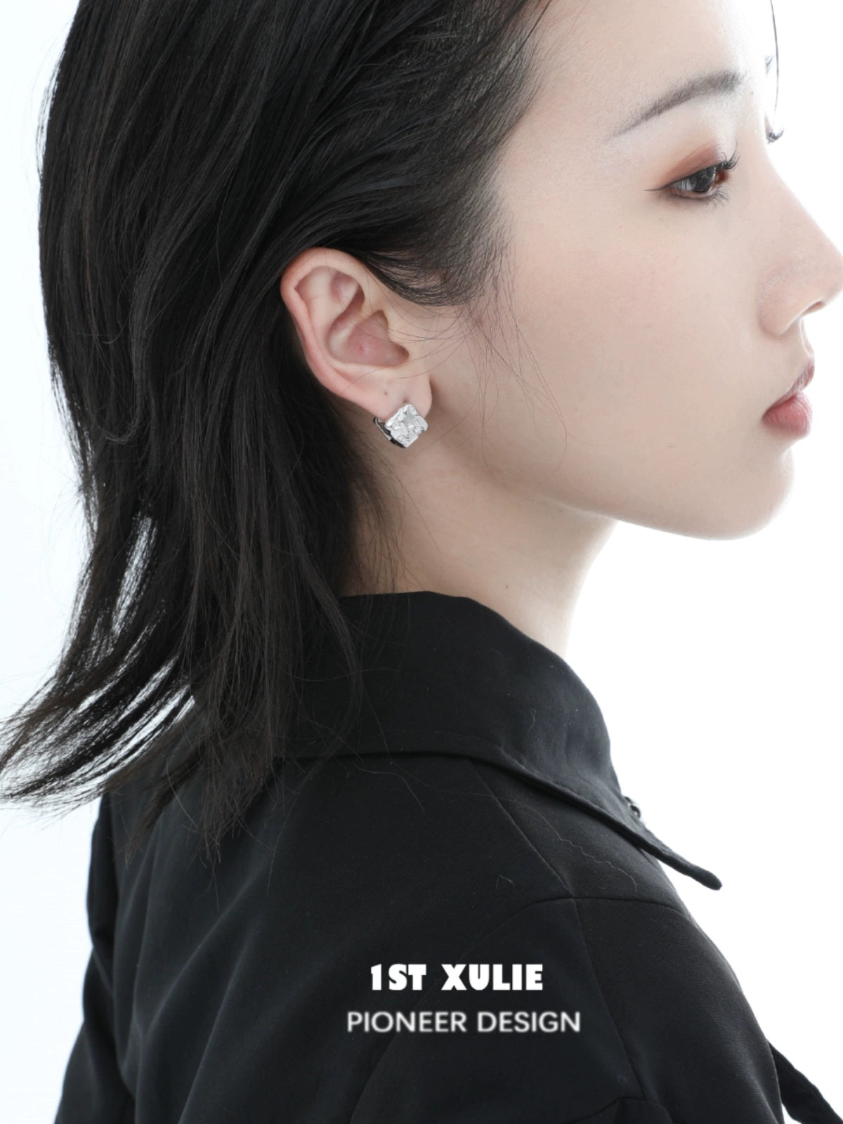 Model wearing Y2K textured earrings with a sleek hairstyle and minimal makeup for a modern look