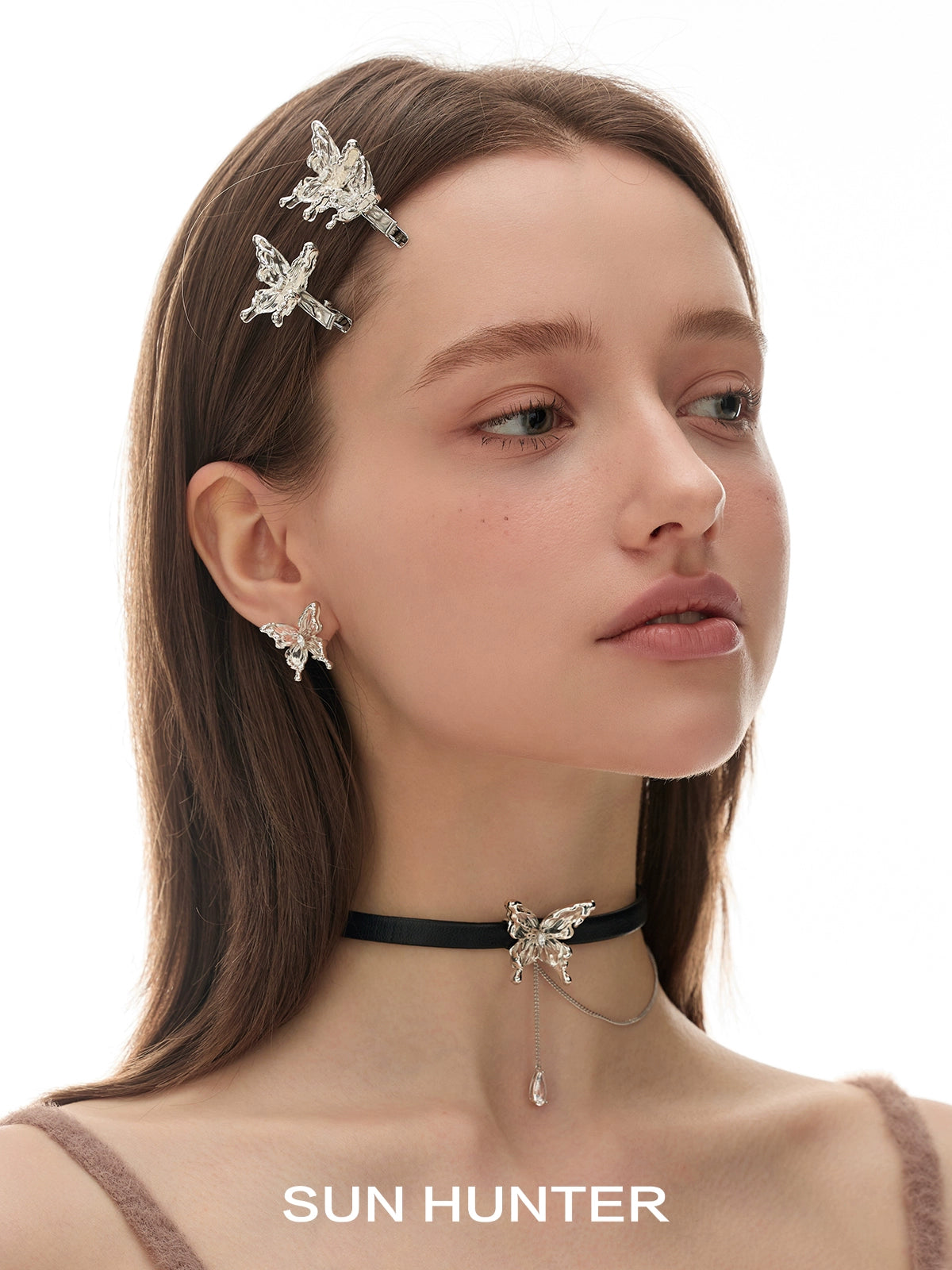 Elegant model wearing SUN HUNTER 3D butterfly earrings with matching accessories for a stylish look