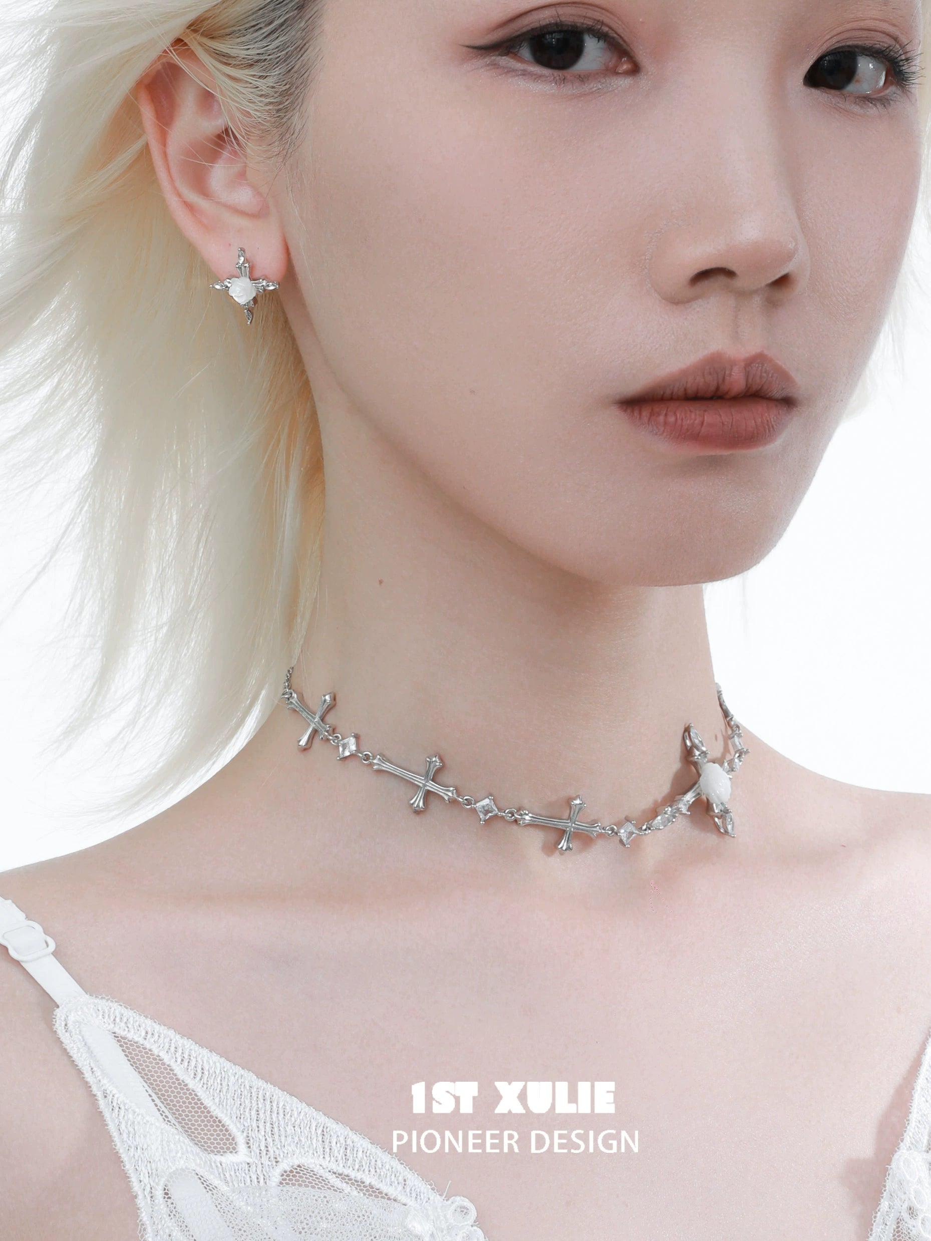 Elegant silver rose cross necklace paired with matching earrings for a stylish look