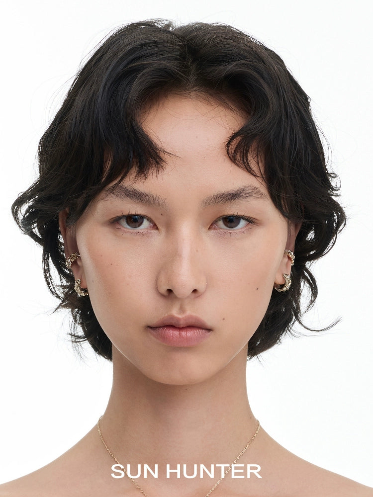Model wearing a vintage iris ear cuff from SUN HUNTER showcasing a unique design