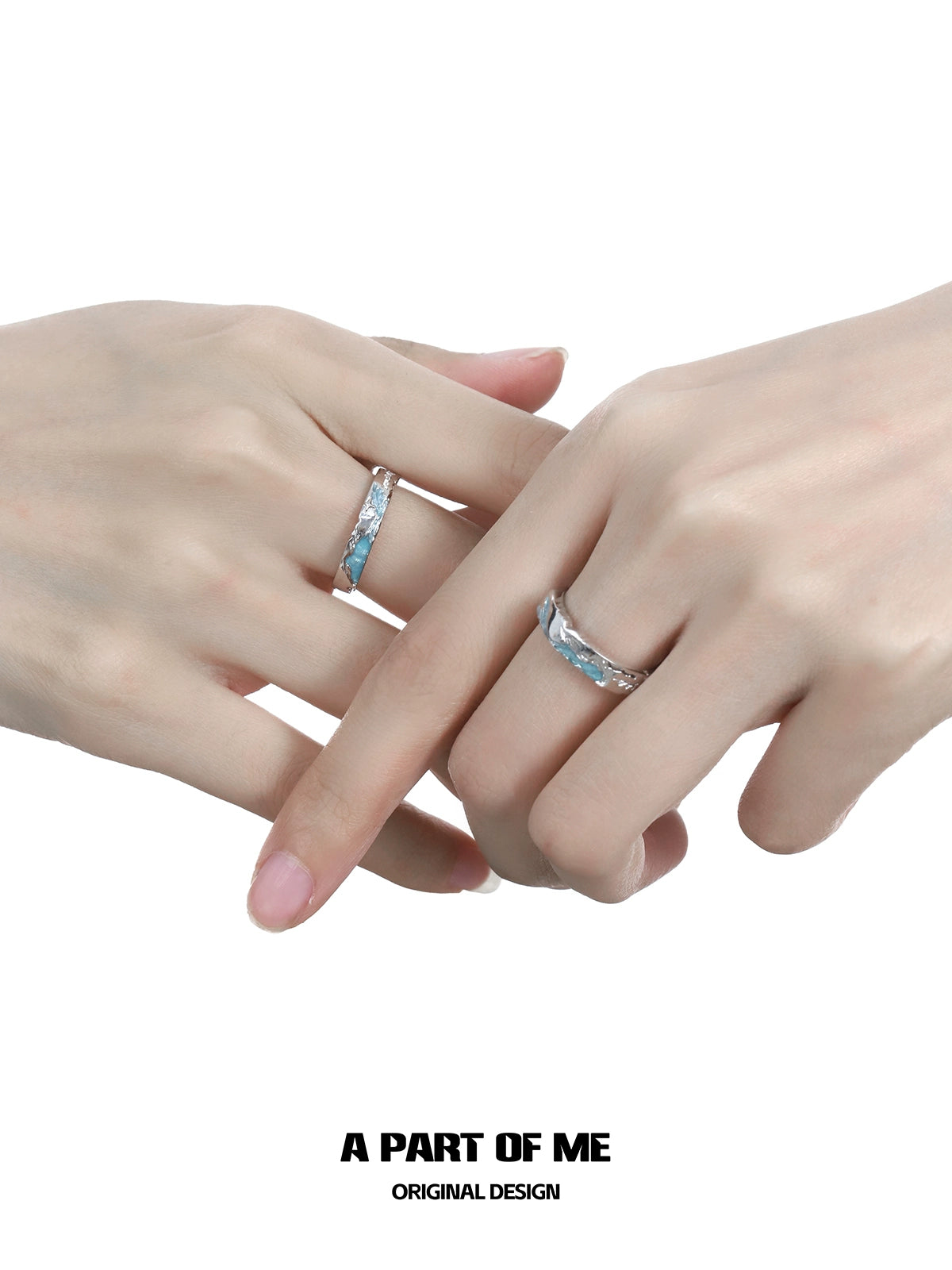 A pair of hands wearing the A PART OF ME azure dream fish ring featuring a sleek design