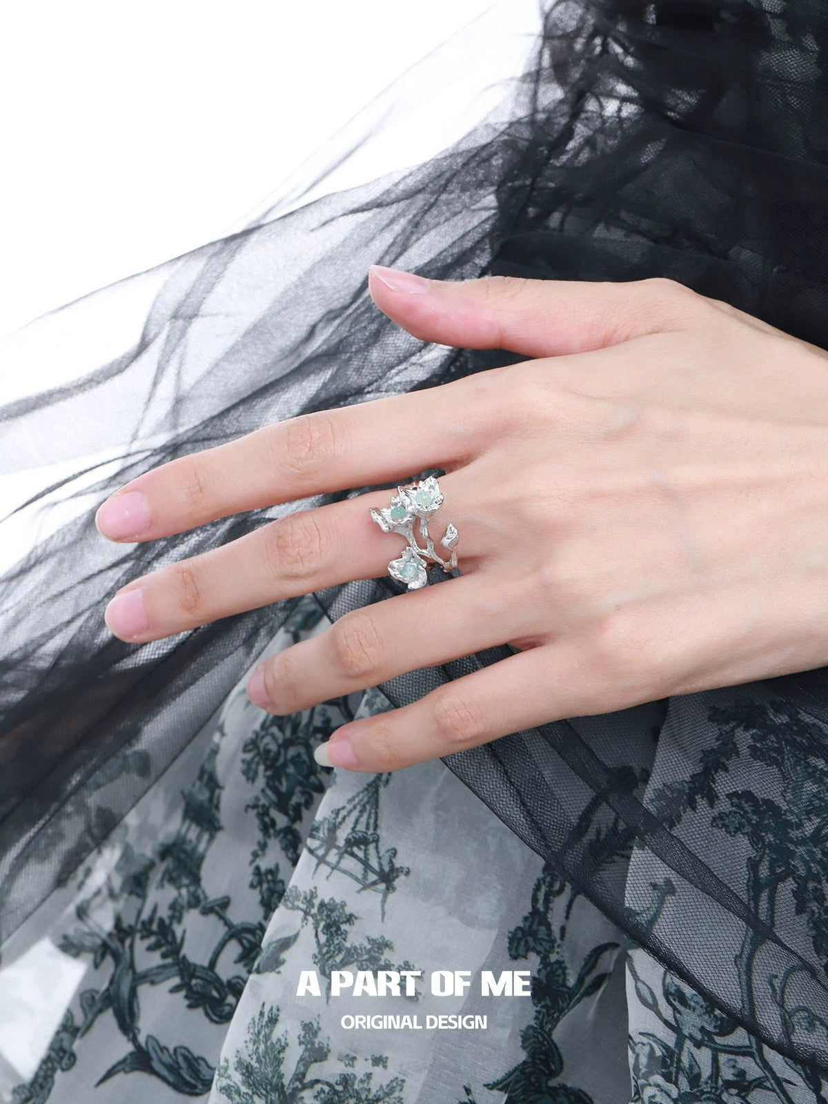 Elegant blue flower ring featuring delicate floral design on a stylish hand model
