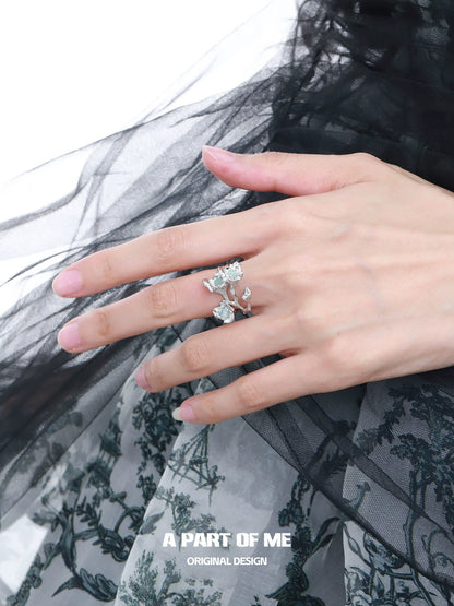 Elegant blue flower ring featuring delicate floral design on a stylish hand model