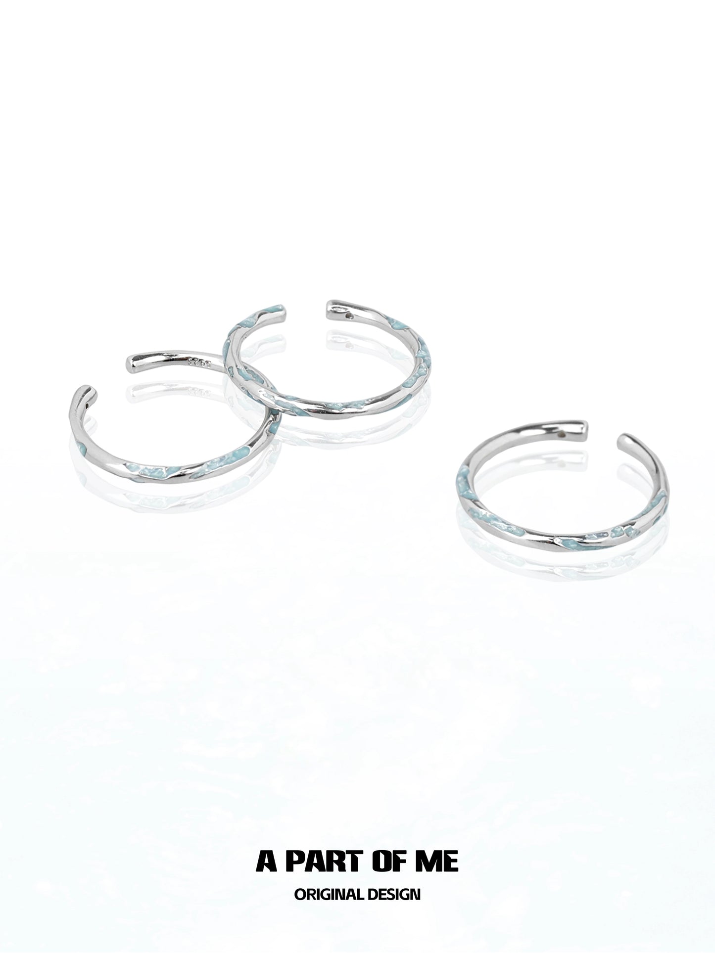 Set of three A PART OF ME blue minimalist ring designs with a sleek silver finish