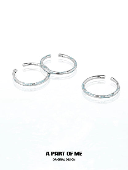 Set of three A PART OF ME blue minimalist ring designs with a sleek silver finish