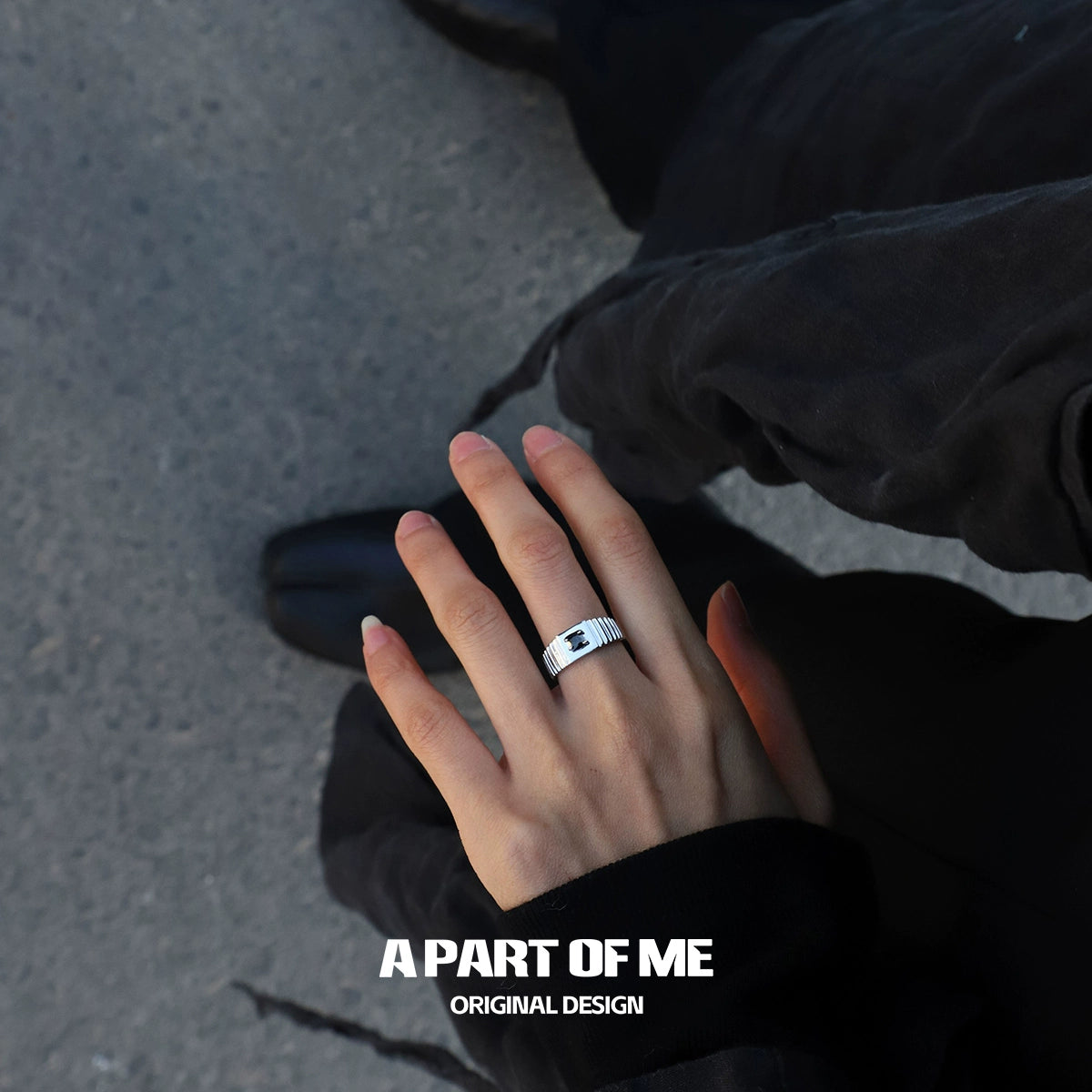 Stylish hand wearing a bold stone hip-hop ring by A PART OF ME for a trendy urban look